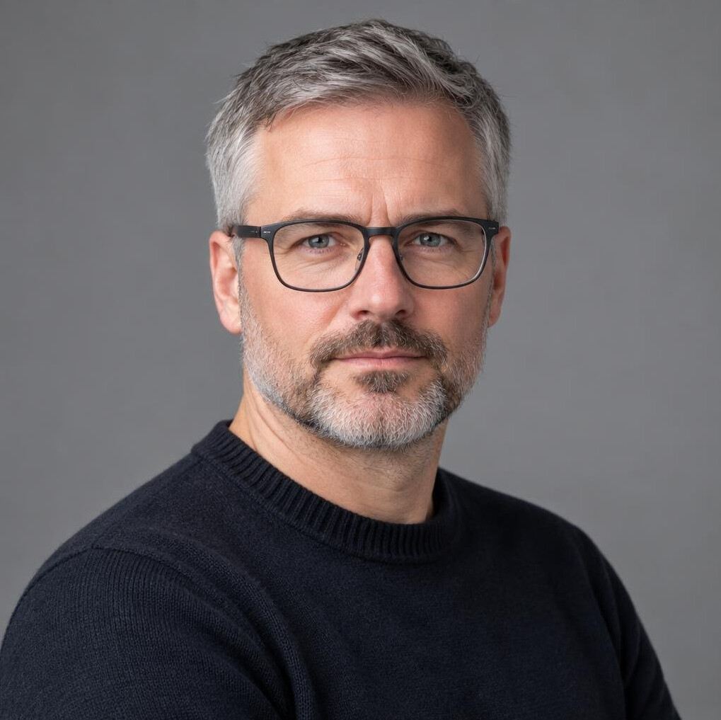 Studio portrait of a man with glasses and a beard